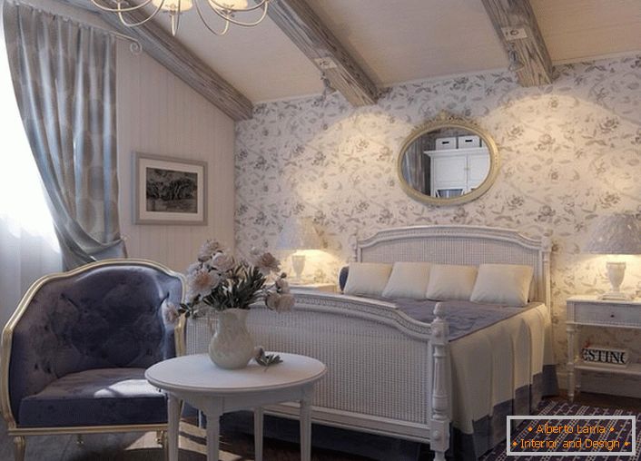 Mobila dormitorului în stil rustic este aleasă armonios. Candelabrele și lămpile de noptieră cu nuanțe clasice sunt demne de remarcat.