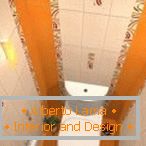 Combinația de dale de culoare albă și portocalie în designul toaletei