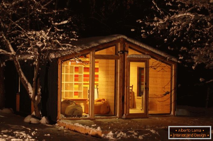 O casă fabuloasă pe marginea zăpezii unei păduri. Avantajul unei locuințe modulare este caracterul practic și funcționalitatea acesteia.