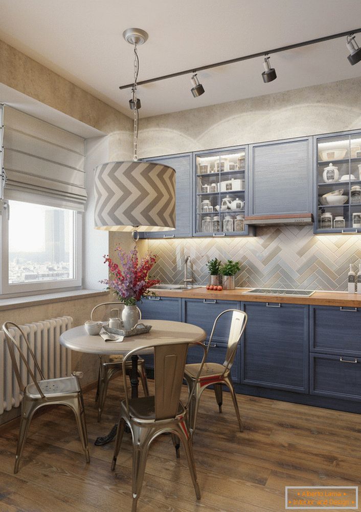 Culoarea albastră palidă a setului de bucătărie este o soluție excelentă pentru bucătăria eclectică. Un exemplu de iluminare perfect selectată, care iluminează separat zona de lucru și masa de luat masa.